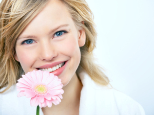 Young girl smelling flower